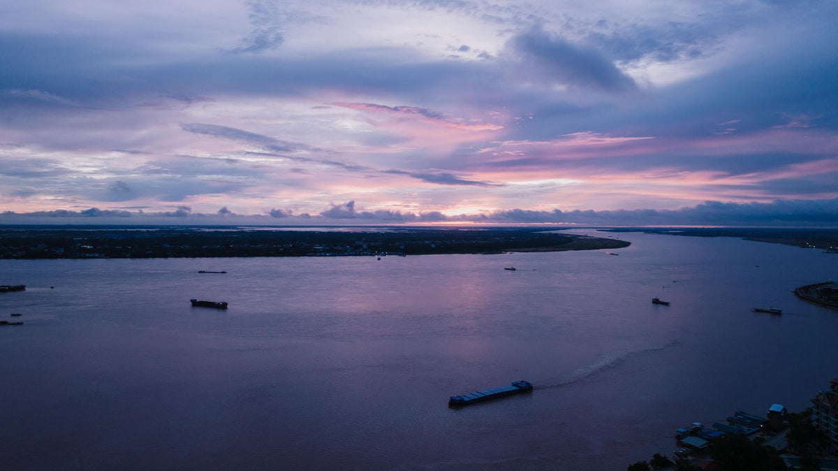 Sunset over the Mekong River in Phnom Penh with boats