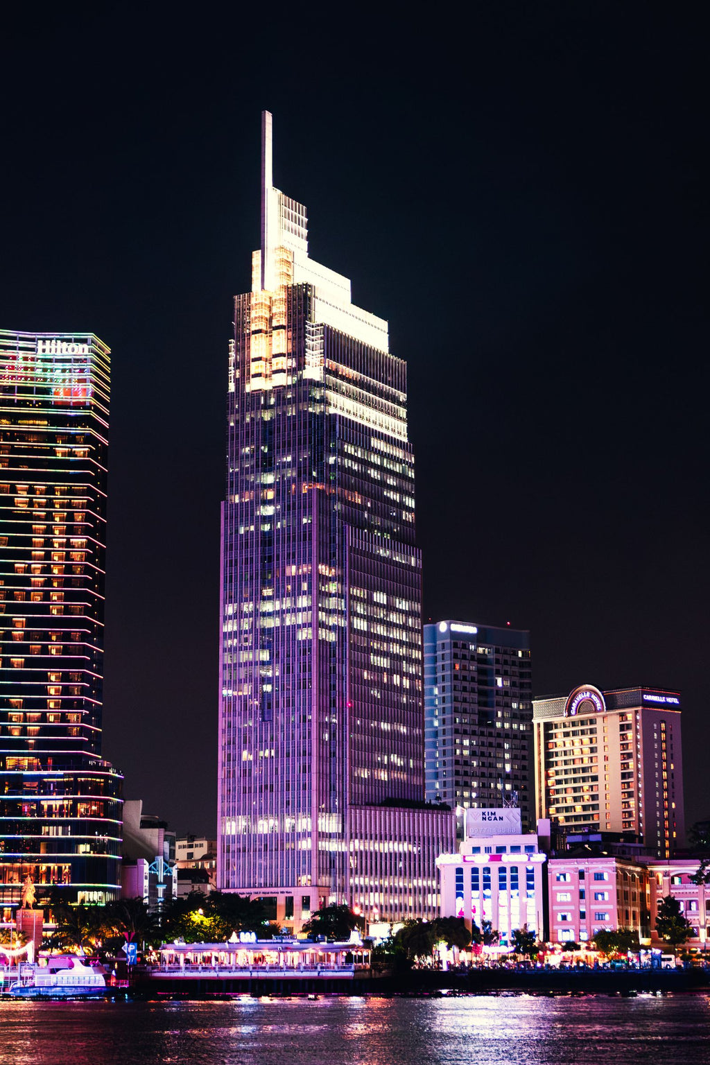 Skyscrapers reflected in the Saigon River at night