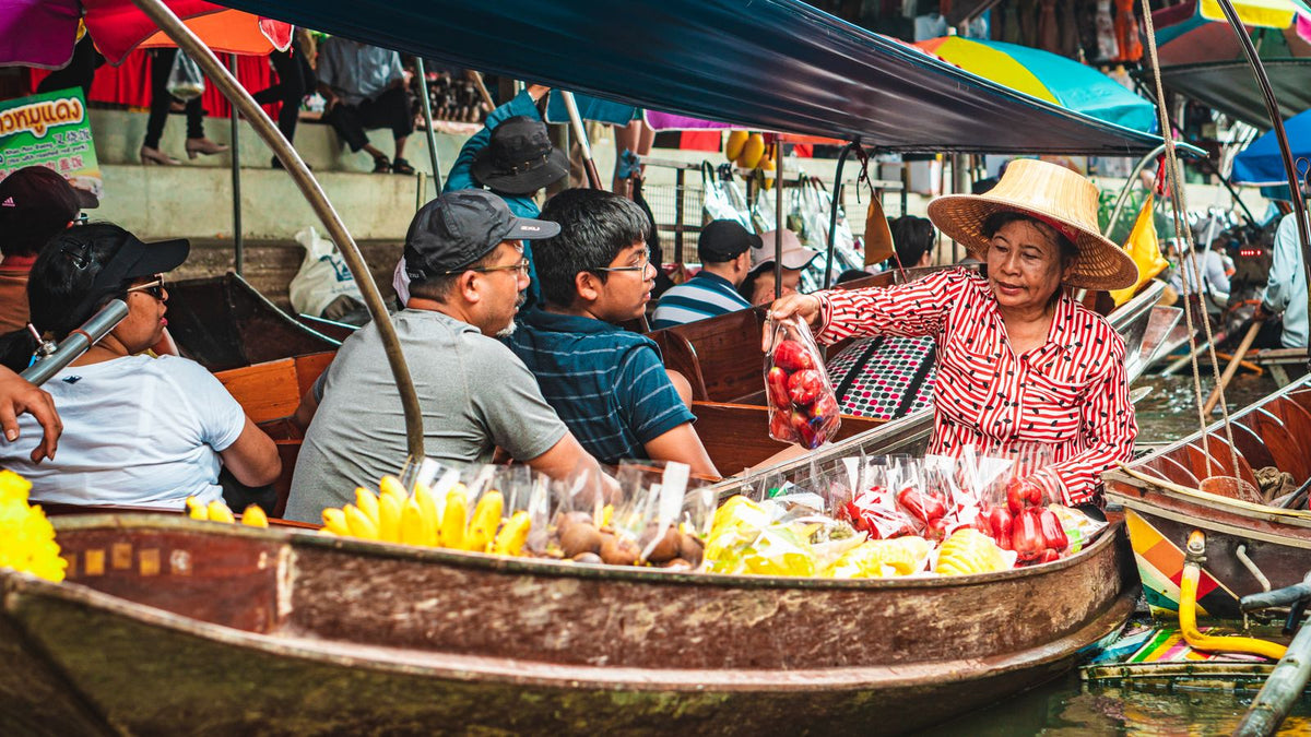 Vendors selling fruit at a floating market