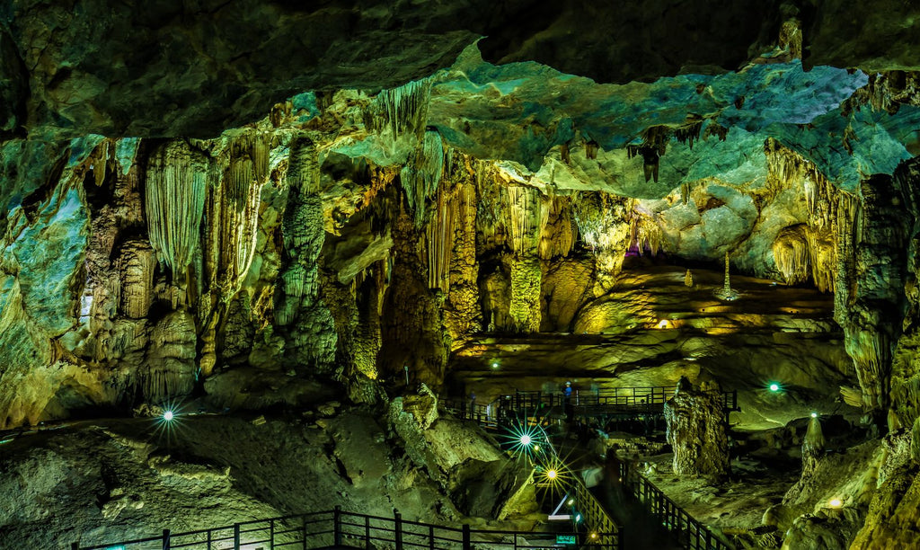Illuminated stalactites in a Quang Binh cave